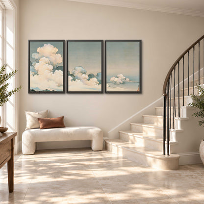 Soft cream clouds gathered low in a muted blue-green sky 3 piece framed canvas wall art styled in an interior
