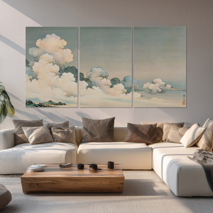 Soft cream clouds gathered low in a muted blue-green sky set of 3 poster prints displayed in a living room