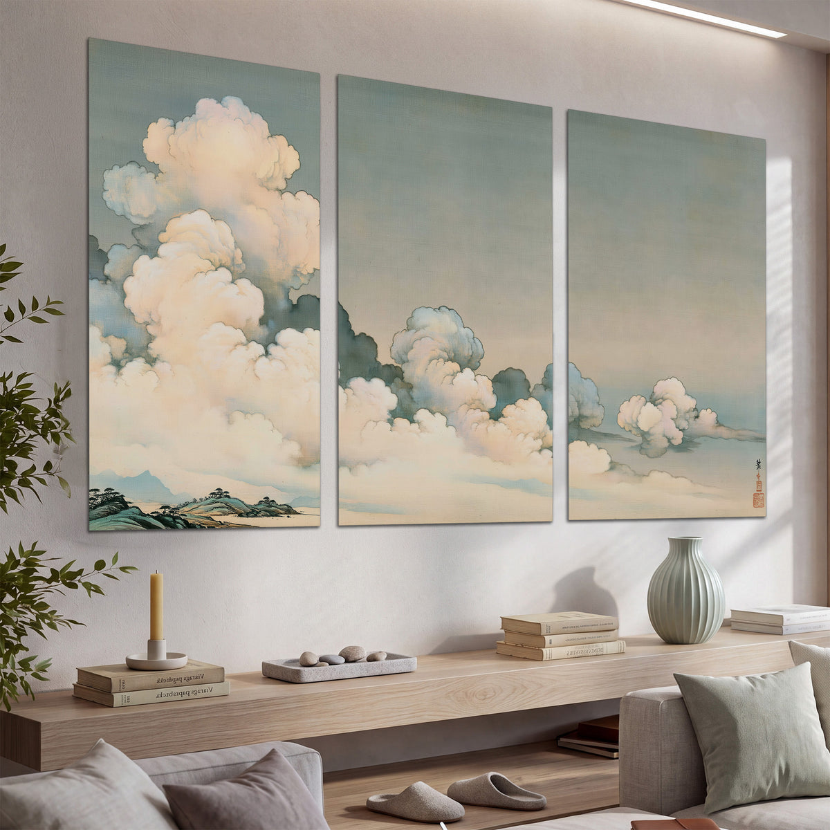 Soft cream clouds gathered low in a muted blue-green sky set of 3 poster prints displayed in a console