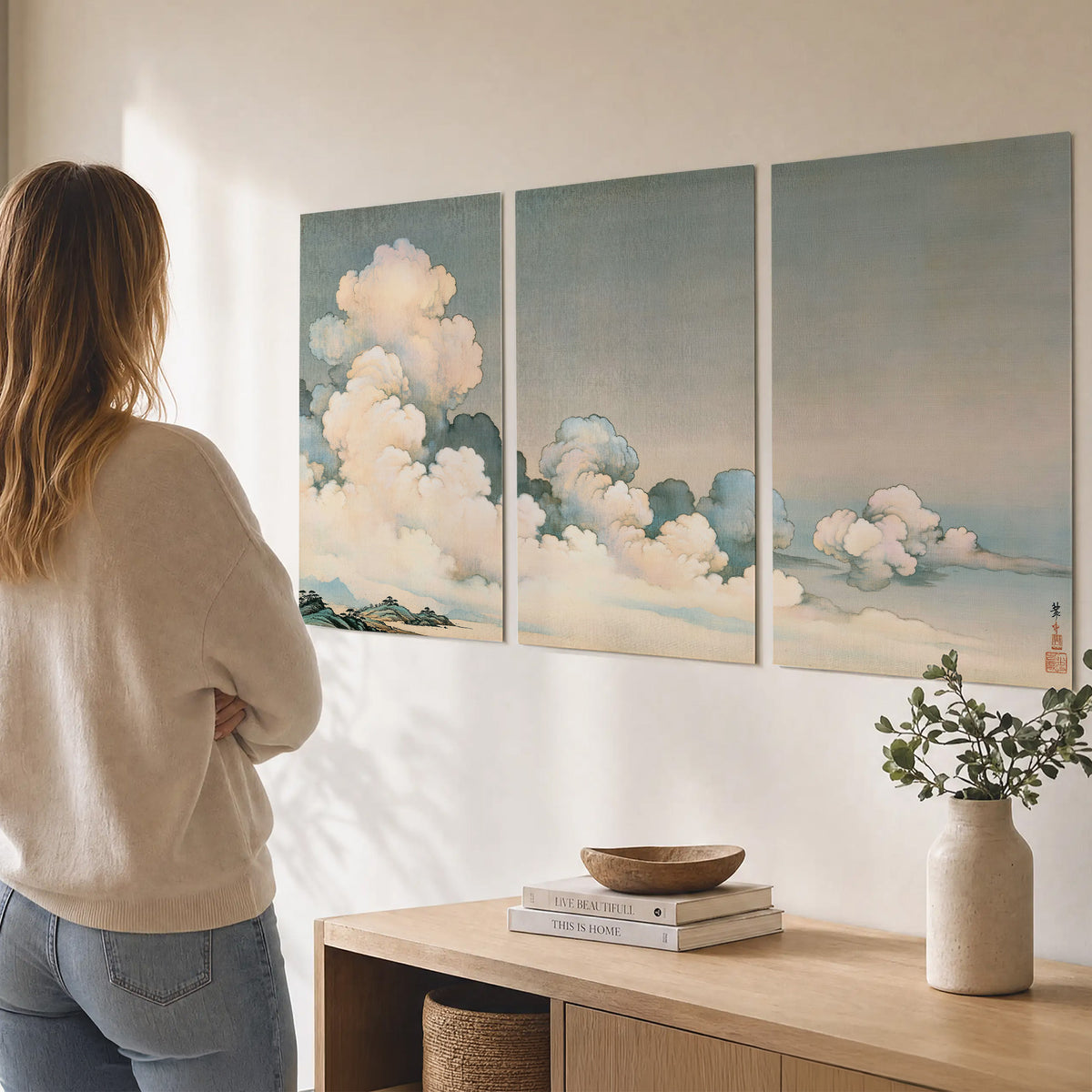 Soft cream clouds gathered low in a muted blue-green sky set of 3 poster prints three panel arrangement on a wall