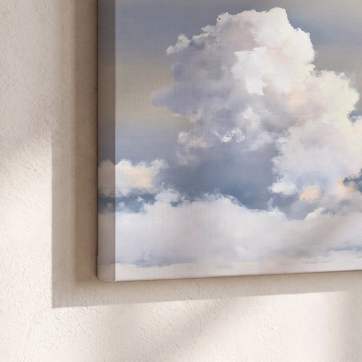 Large white clouds rising through a pale blue sky with gentle warm highlights 3 piece canvas wall art material and edge close up