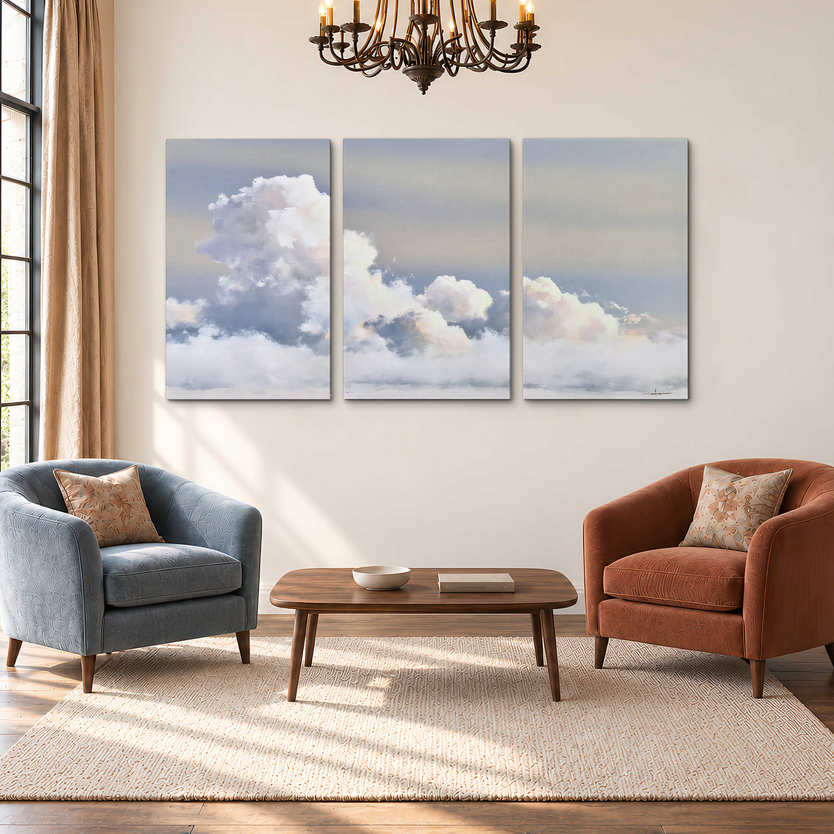 Large white clouds rising through a pale blue sky with gentle warm highlights 3 piece canvas wall art styled in an interior