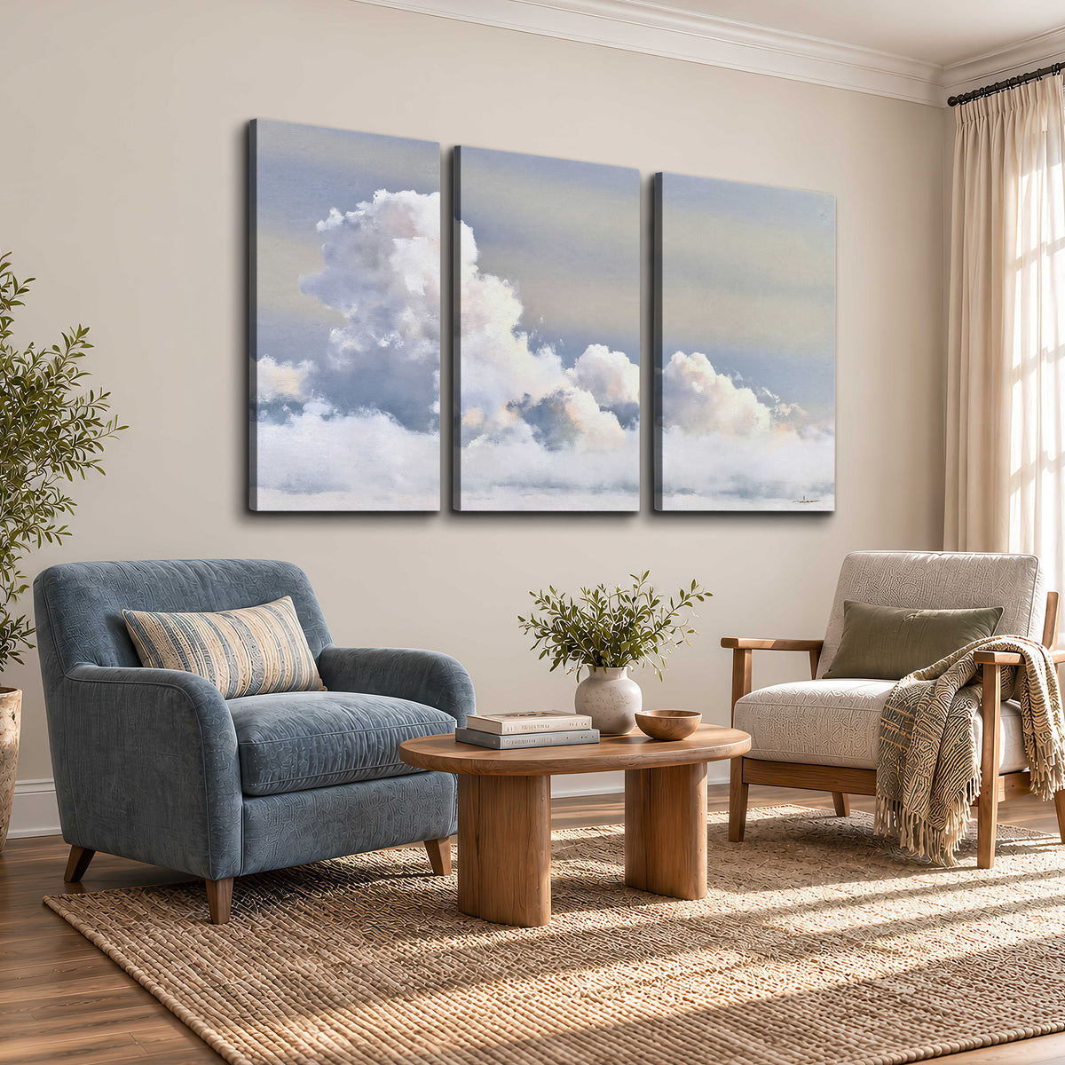 Large white clouds rising through a pale blue sky with gentle warm highlights 3 piece canvas wall art styled in an interior