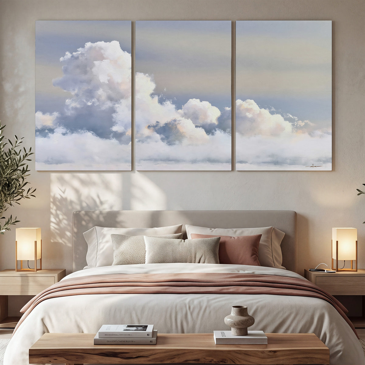 Large white clouds rising through a pale blue sky with gentle warm highlights 3 piece canvas wall art displayed in a bedroom