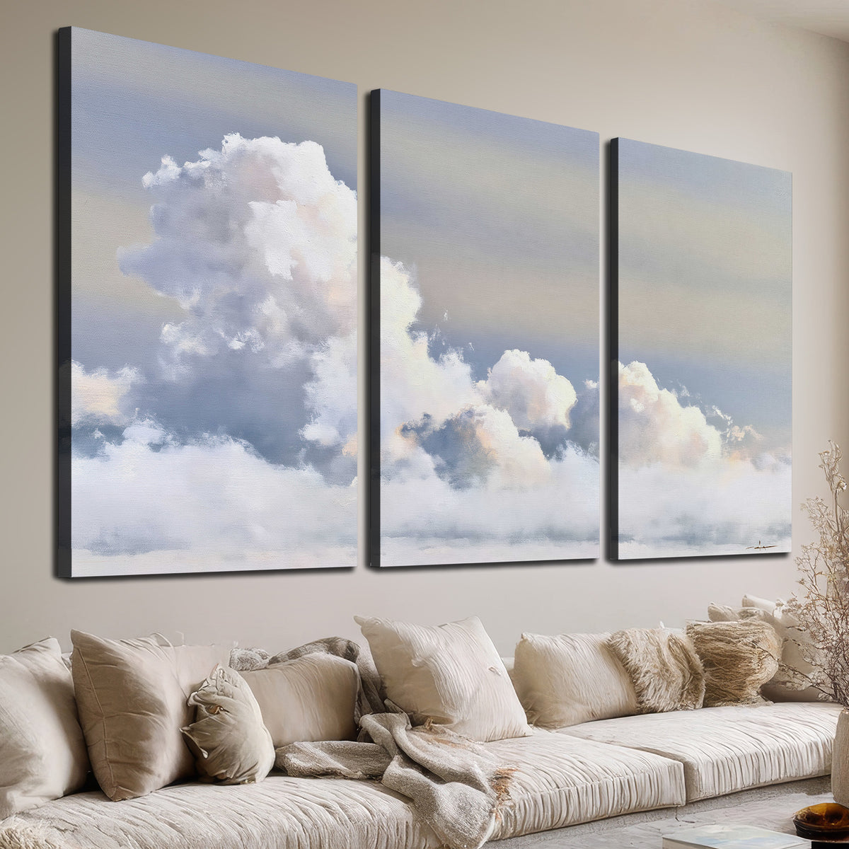 Large white clouds rising through a pale blue sky with gentle warm highlights 3 piece canvas wall art room and product view