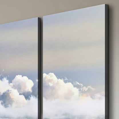 Large white clouds rising through a pale blue sky with gentle warm highlights 3 piece canvas wall art room and product view