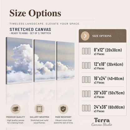 Large white clouds rising through a pale blue sky with gentle warm highlights 3 piece canvas wall art available dimensions; triptych dimensions are per panel