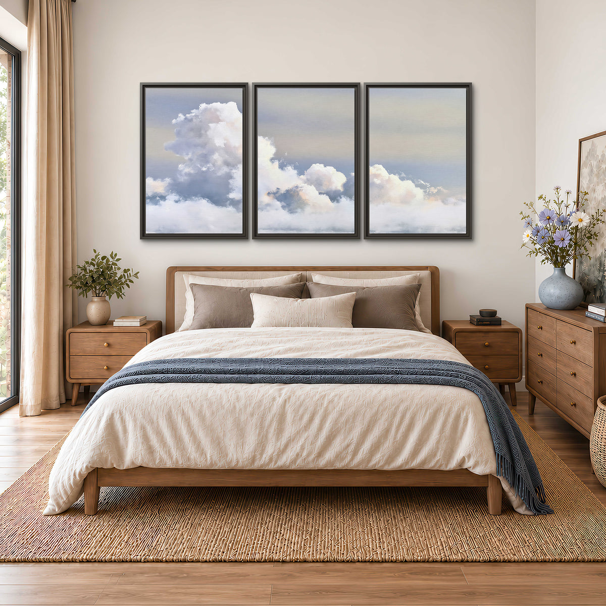 Large white clouds rising through a pale blue sky with gentle warm highlights 3 piece framed canvas wall art styled in an interior