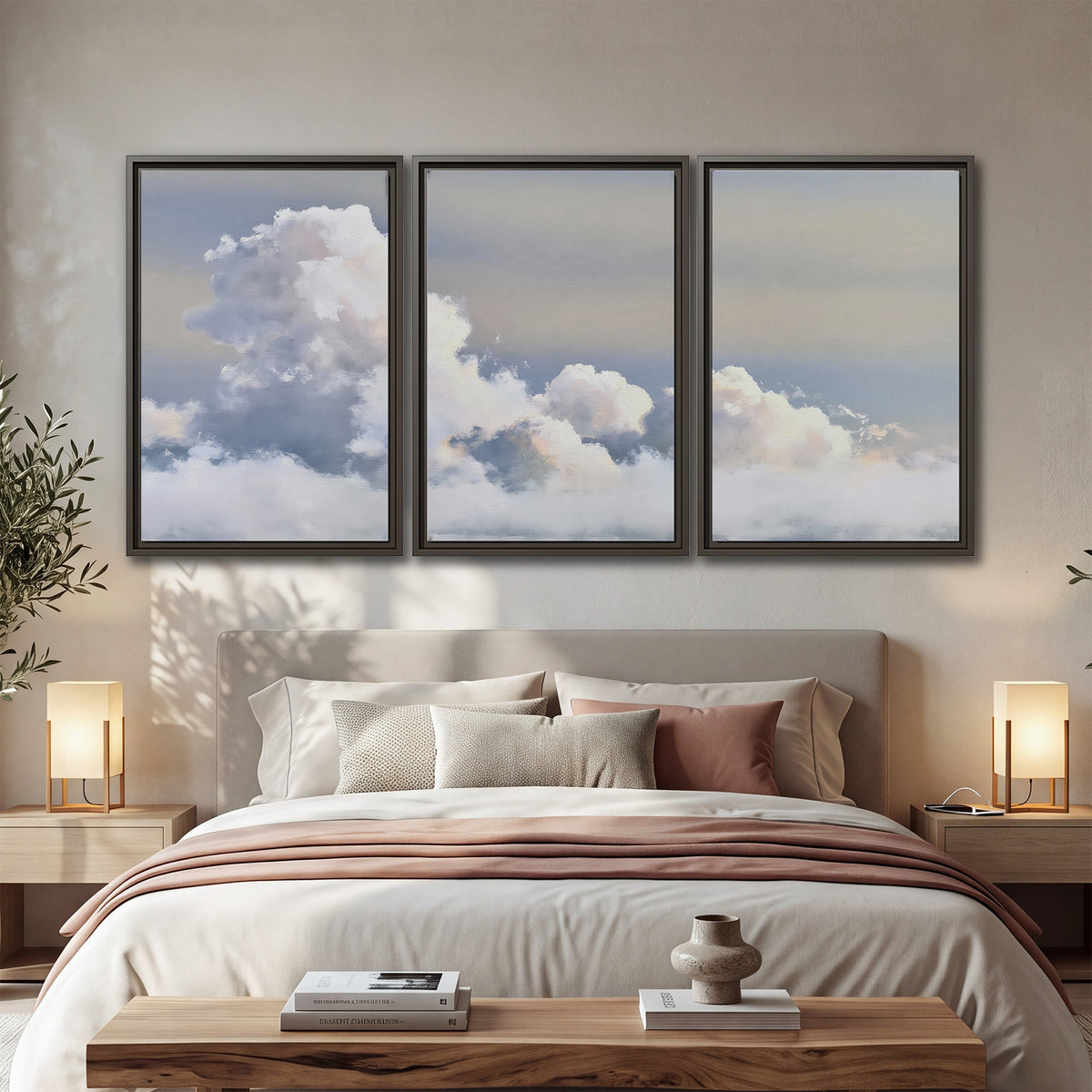 Large white clouds rising through a pale blue sky with gentle warm highlights 3 piece framed canvas wall art displayed in a bedroom
