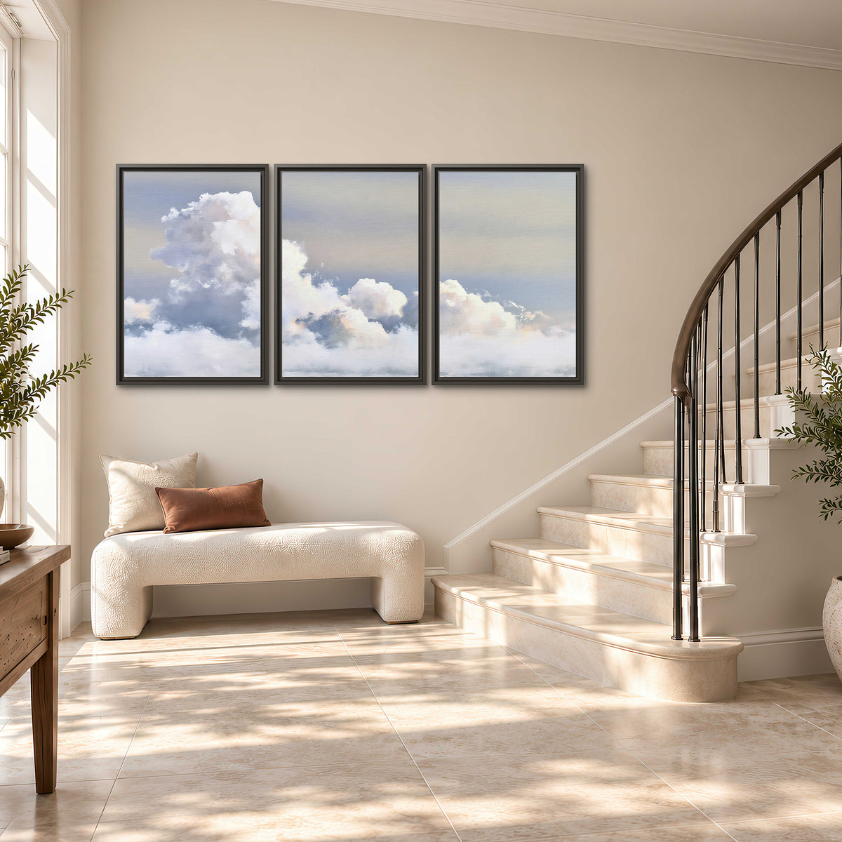 Large white clouds rising through a pale blue sky with gentle warm highlights 3 piece framed canvas wall art styled in an interior