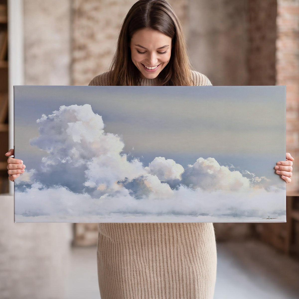 Large white clouds rising through a pale blue sky with gentle warm highlights single canvas wall art held in hands