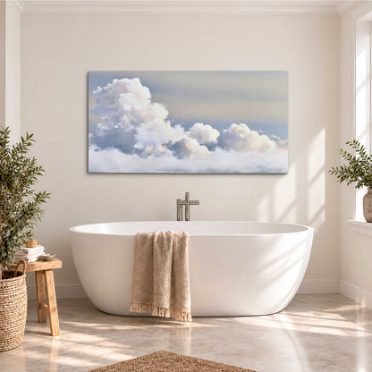 Large white clouds rising through a pale blue sky with gentle warm highlights single canvas wall art styled in an interior