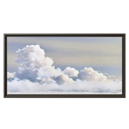 Large white clouds rising through a pale blue sky with gentle warm highlights single framed canvas wall art viewed straight on