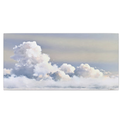 Large white clouds rising through a pale blue sky with gentle warm highlights single canvas wall art viewed straight on