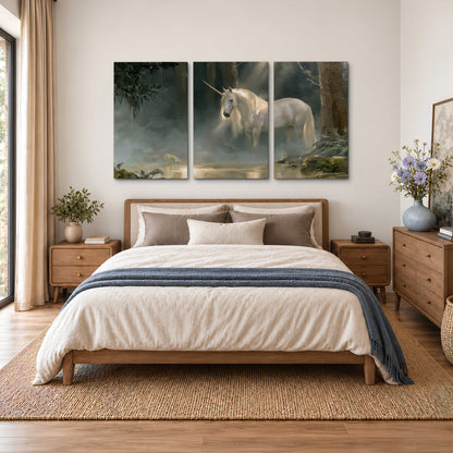 A white unicorn standing near rocks and a quiet stream in a green woodland 3 piece canvas wall art styled in an interior