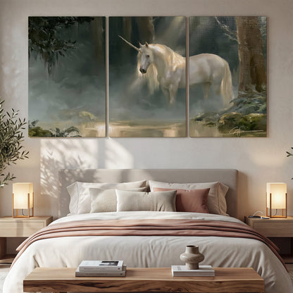 A white unicorn standing near rocks and a quiet stream in a green woodland 3 piece canvas wall art displayed in a bedroom