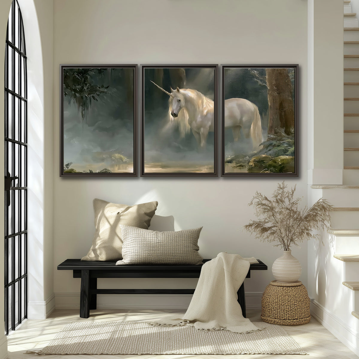 A white unicorn standing near rocks and a quiet stream in a green woodland 3 piece framed canvas wall art displayed in a entryway