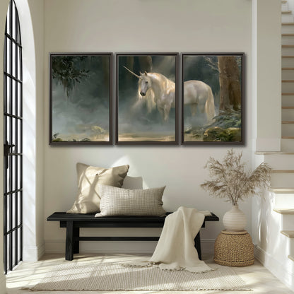 A white unicorn standing near rocks and a quiet stream in a green woodland 3 piece framed canvas wall art displayed in a entryway