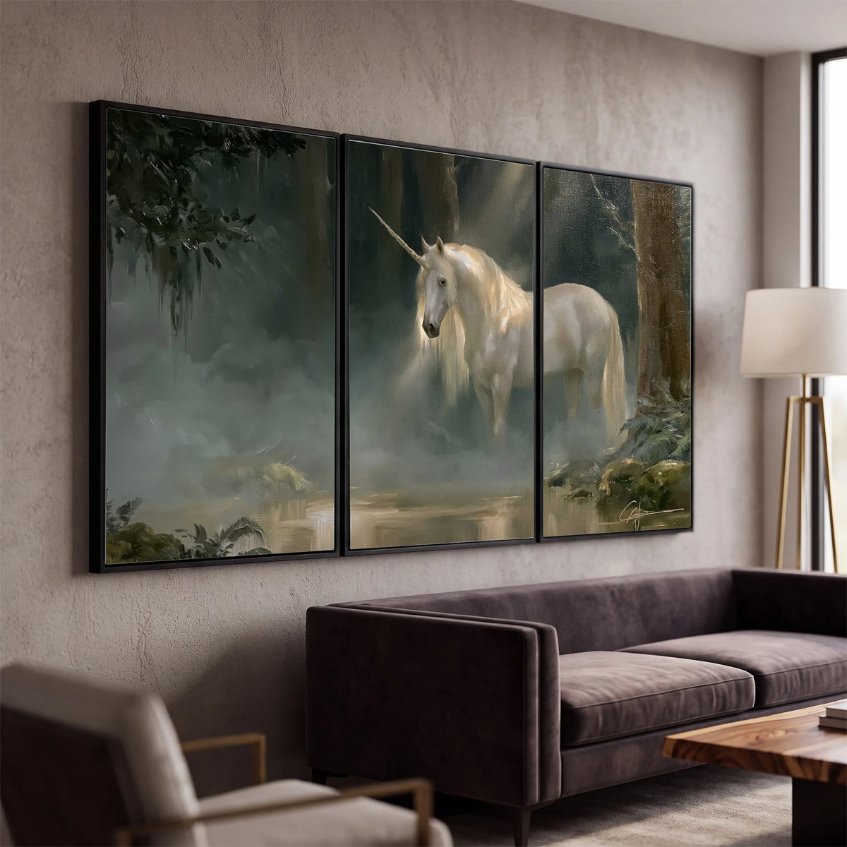 A white unicorn standing near rocks and a quiet stream in a green woodland 3 piece framed canvas wall art displayed in a modern living room