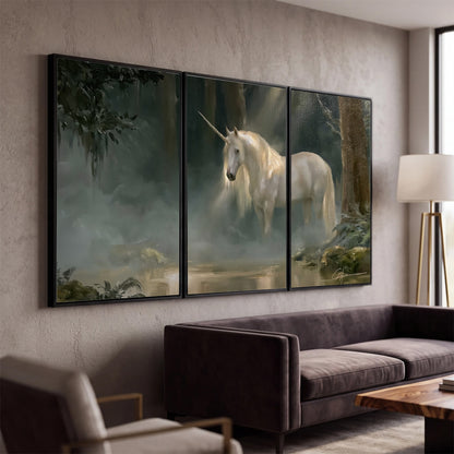 A white unicorn standing near rocks and a quiet stream in a green woodland 3 piece framed canvas wall art displayed in a modern living room