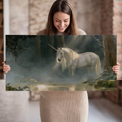 A white unicorn standing near rocks and a quiet stream in a green woodland single canvas wall art held in hands