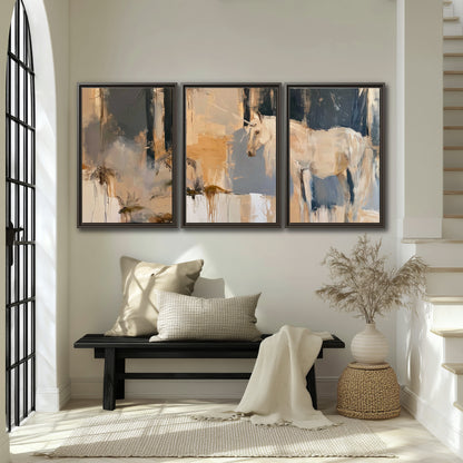 A pale unicorn emerging from loose vertical strokes of blue, ochre and cream 3 piece framed canvas wall art displayed in a entryway