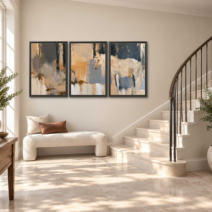 A pale unicorn emerging from loose vertical strokes of blue, ochre and cream 3 piece framed canvas wall art styled in an interior