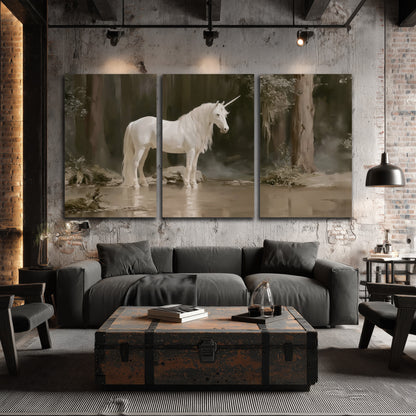 A white unicorn standing beside shallow water beneath tall shadowed trees 3 piece canvas wall art displayed in a industrial room