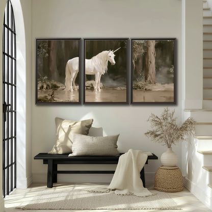 A white unicorn standing beside shallow water beneath tall shadowed trees 3 piece framed canvas wall art displayed in a entryway