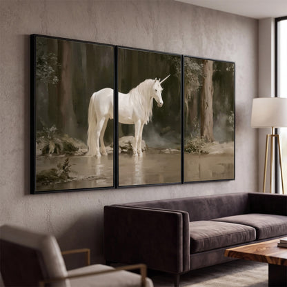 A white unicorn standing beside shallow water beneath tall shadowed trees 3 piece framed canvas wall art displayed in a modern living room