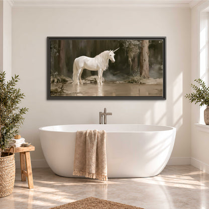 A white unicorn standing beside shallow water beneath tall shadowed trees single framed canvas wall art styled in an interior