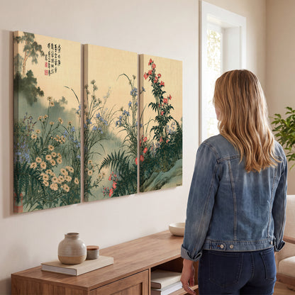 Delicate wildflowers and ferns arranged on a warm neutral ground with decorative script 3 piece canvas wall art three panel arrangement on a wall