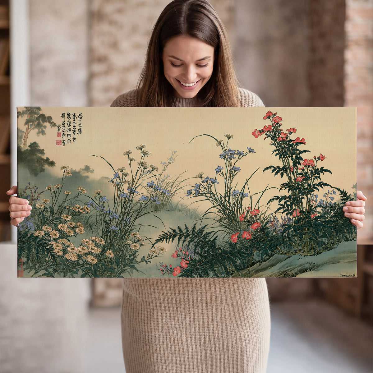 Delicate wildflowers and ferns arranged on a warm neutral ground with decorative script single canvas wall art held in hands
