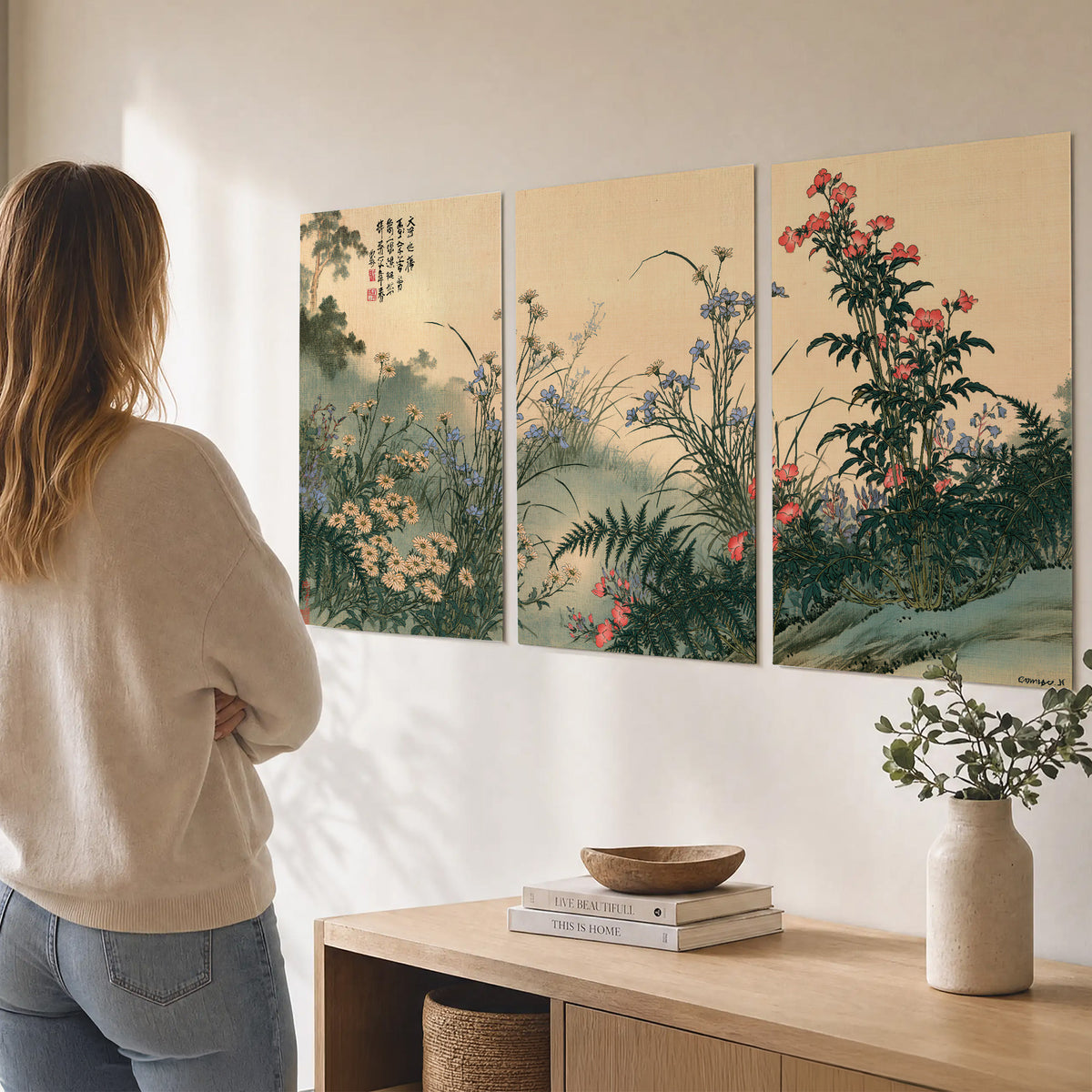 Delicate wildflowers and ferns arranged on a warm neutral ground with decorative script set of 3 poster prints three panel arrangement on a wall