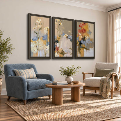 Loose white and yellow flowers set against vertical blue and golden strokes 3 piece framed canvas wall art styled in an interior