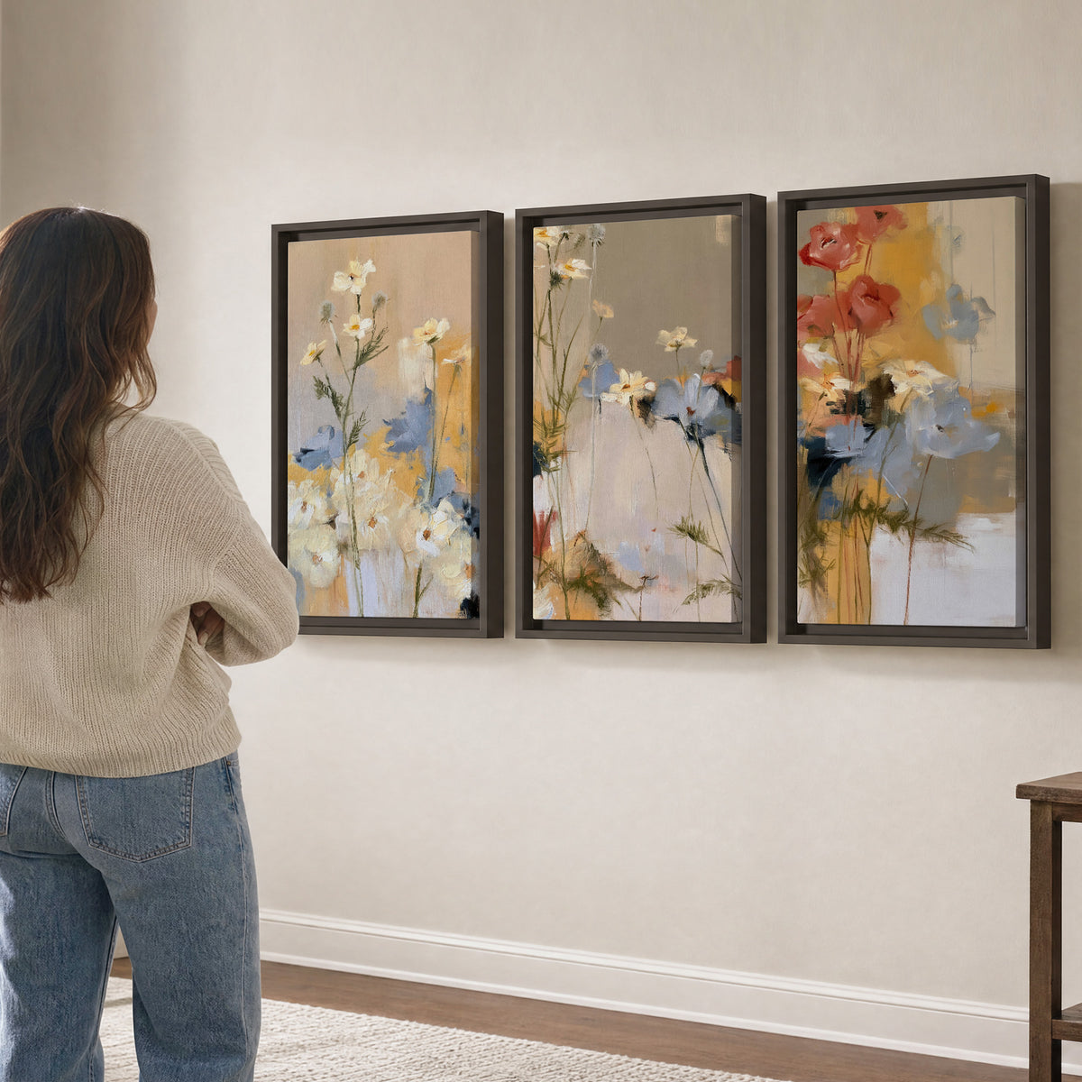 Loose white and yellow flowers set against vertical blue and golden strokes 3 piece framed canvas wall art three panel arrangement on a wall