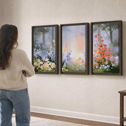 Colorful white, blue and orange flowers beneath a warm shaft of woodland light 3 piece framed canvas wall art three panel arrangement on a wall