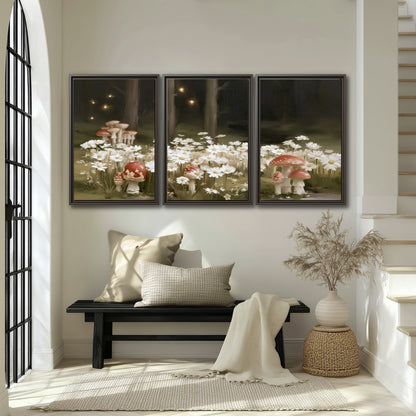 Pale daisies and red-capped mushrooms in a dark meadow with tiny painted points of light 3 piece framed canvas wall art displayed in a entryway