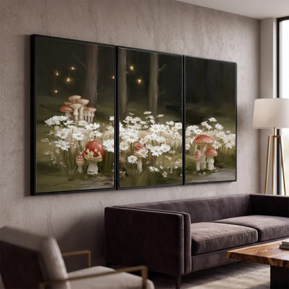 Pale daisies and red-capped mushrooms in a dark meadow with tiny painted points of light 3 piece framed canvas wall art displayed in a modern living room