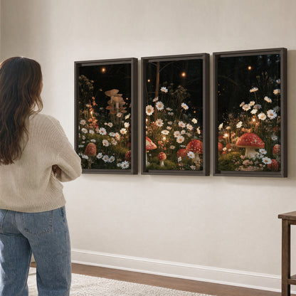 Red mushrooms and delicate white flowers glowing in a painted nighttime woodland scene 3 piece framed canvas wall art three panel arrangement on a wall