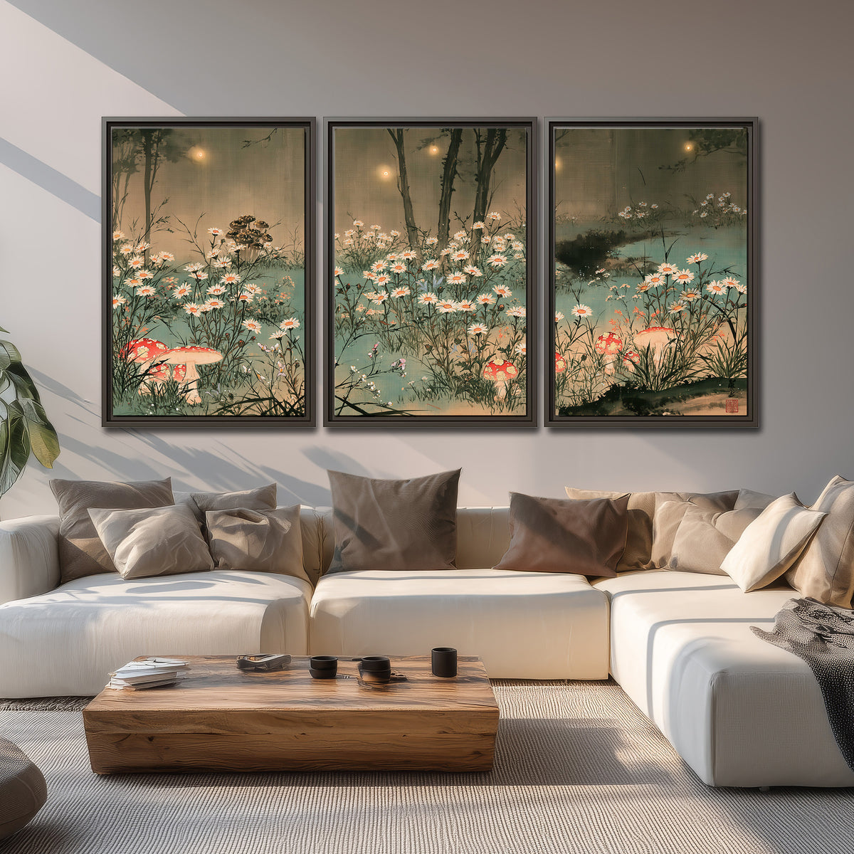 A wide meadow of white daisies and small red mushrooms beneath dark woodland trees 3 piece framed canvas wall art displayed in a living room