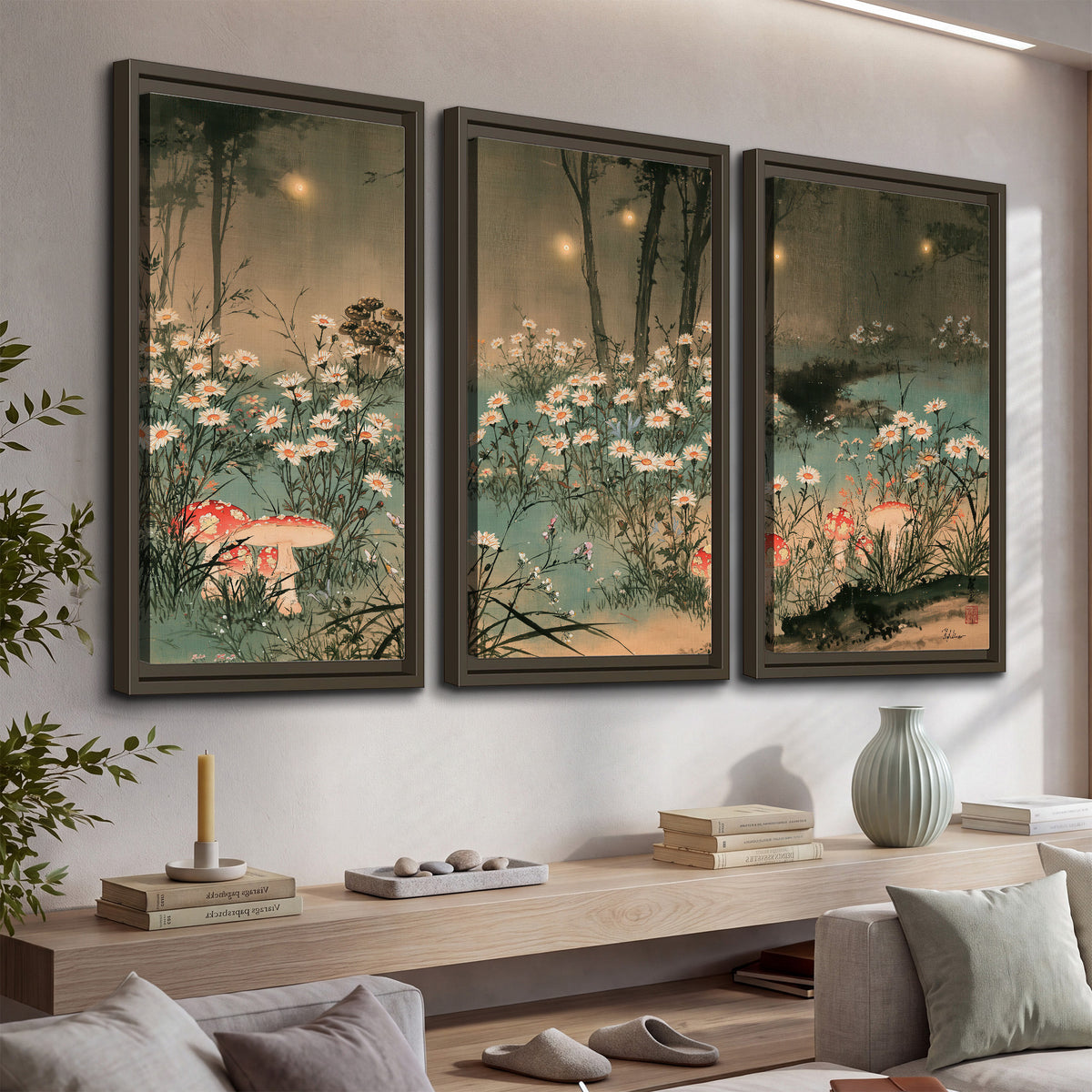 A wide meadow of white daisies and small red mushrooms beneath dark woodland trees 3 piece framed canvas wall art displayed in a console