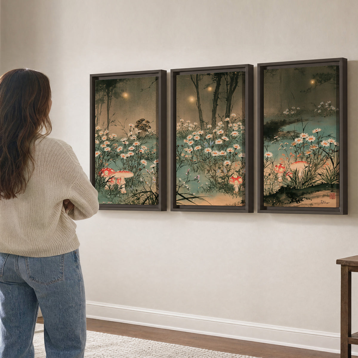 A wide meadow of white daisies and small red mushrooms beneath dark woodland trees 3 piece framed canvas wall art three panel arrangement on a wall