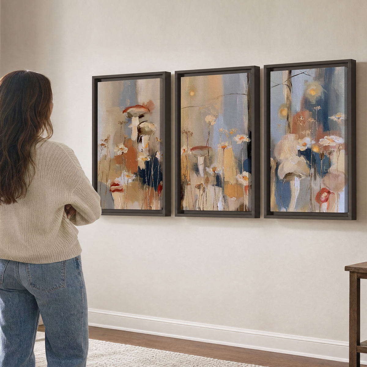 Loose mushroom and flower forms among vertical blue, ochre and cream strokes 3 piece framed canvas wall art three panel arrangement on a wall