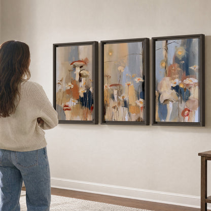 Loose mushroom and flower forms among vertical blue, ochre and cream strokes 3 piece framed canvas wall art three panel arrangement on a wall