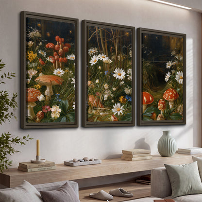 White daisies and warm red mushrooms scattered across a dark woodland garden 3 piece framed canvas wall art displayed in a console