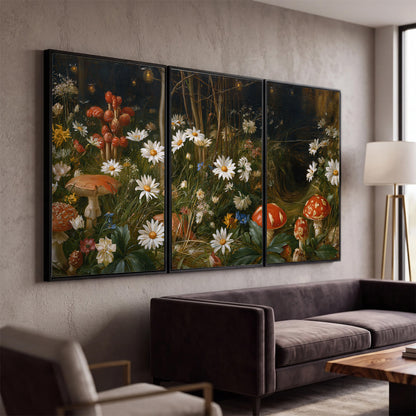 White daisies and warm red mushrooms scattered across a dark woodland garden 3 piece framed canvas wall art displayed in a modern living room