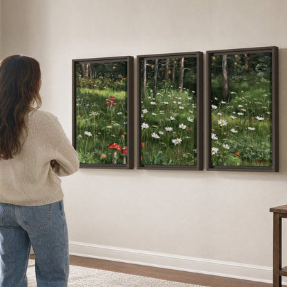 A green woodland floor covered with small white daisies and red mushroom accents 3 piece framed canvas wall art three panel arrangement on a wall