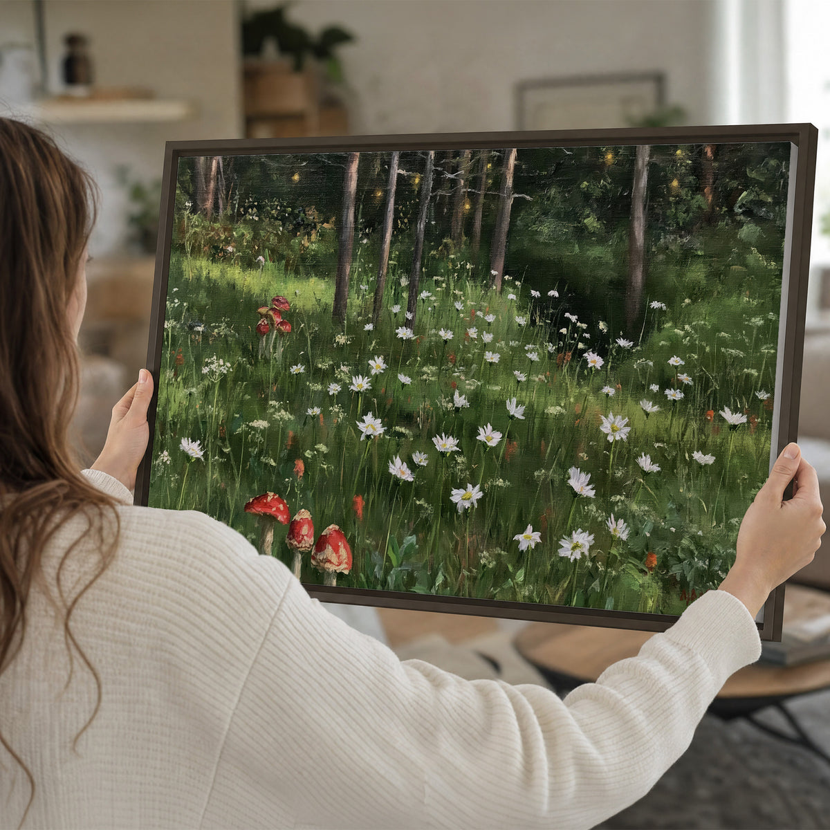 A green woodland floor covered with small white daisies and red mushroom accents single framed canvas wall art held in hands