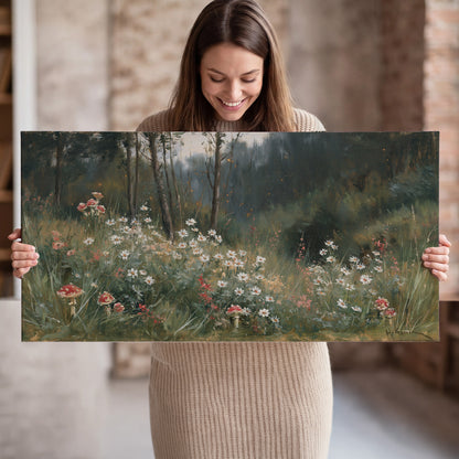 A soft woodland meadow filled with pale flowers and scattered warm red accents single canvas wall art held in hands